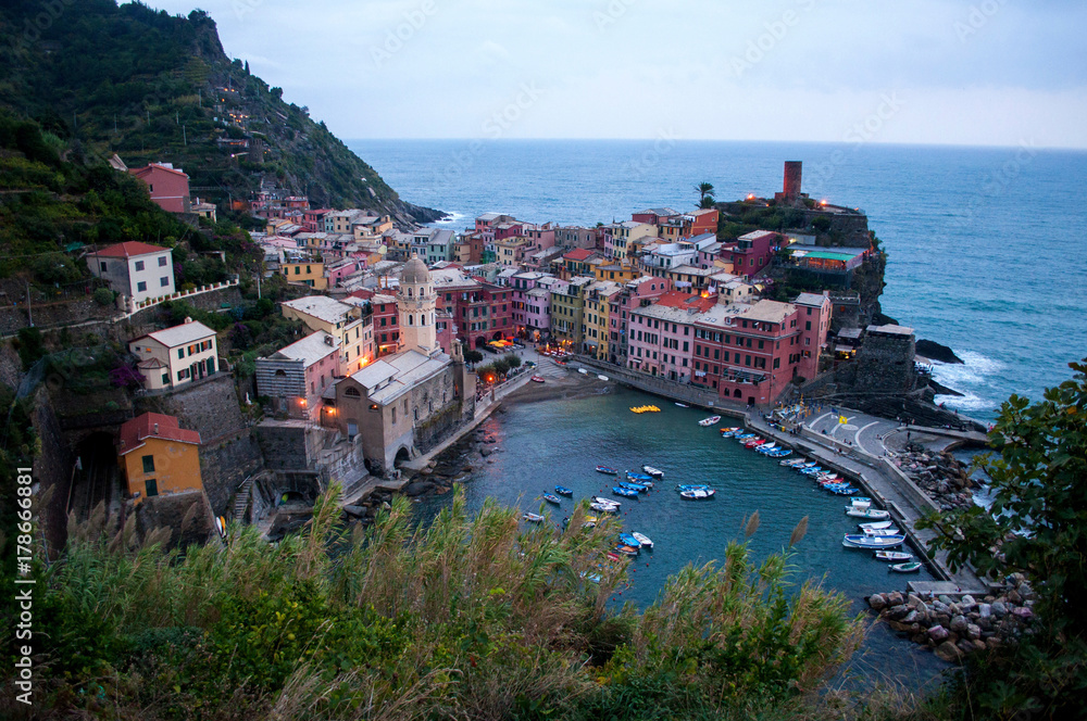 Evening view of a picturesque Italian city with a harbor