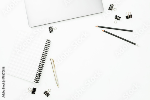 Home office desktop workspace with laptop, notebook and pen on white table. Top view. Flat lay lifestyle concept.