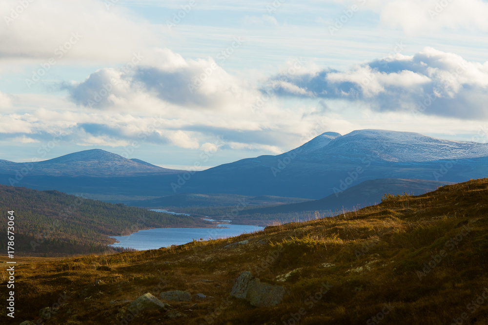 A beautiful mountain landscape with a lake in the distance. Autumn mountains in Norway. Fall scenery in Scandinavia.