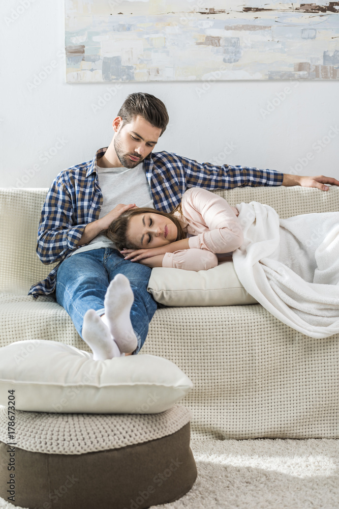 Young man watches girlfriend sleep Young man watches girlfriend sleep