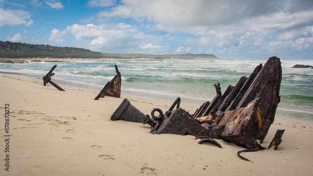 The rusty remains of a wreck of an old trawler on the beach at Cape Point, South Africa