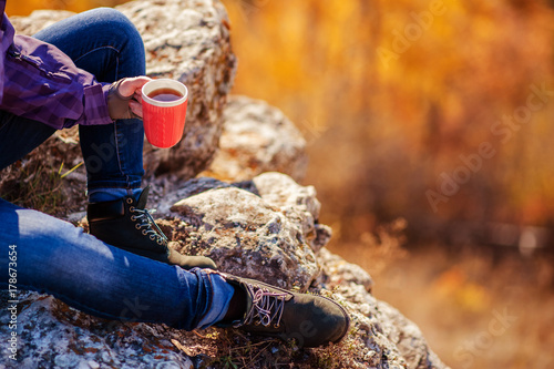 on top of the mountain girl holding a hot mug of tea