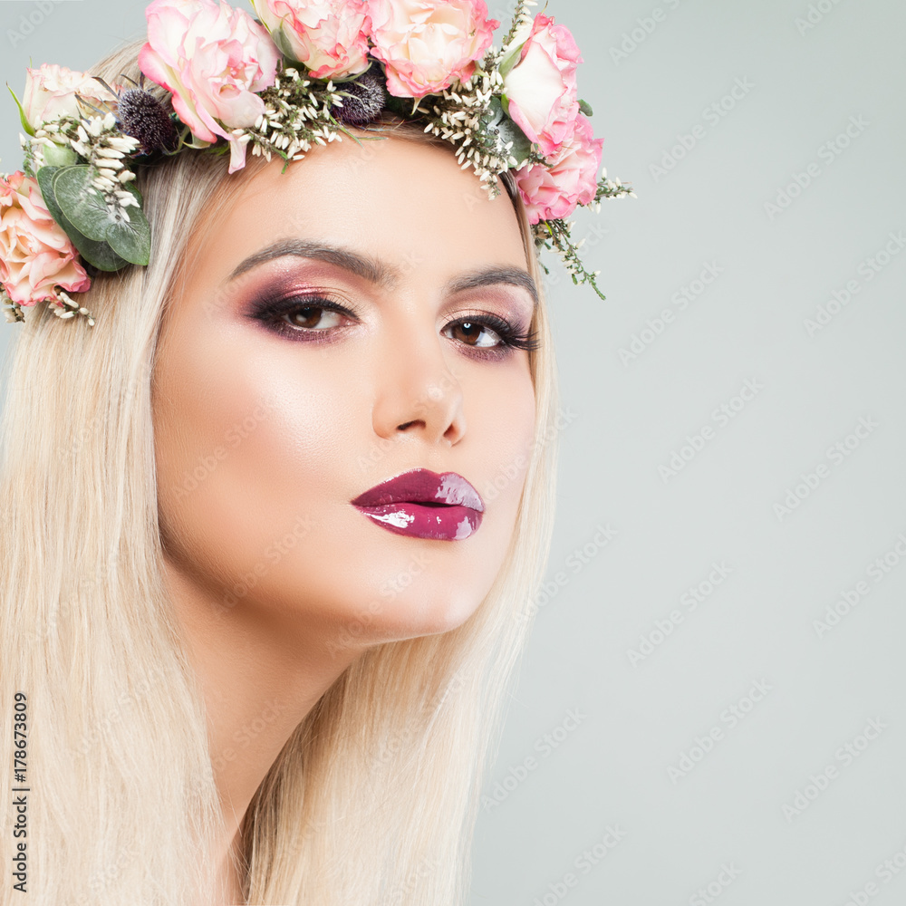Fashion Model Woman with Perfect Makeup and Spring Flowers. Beautiful Female Face Closeup