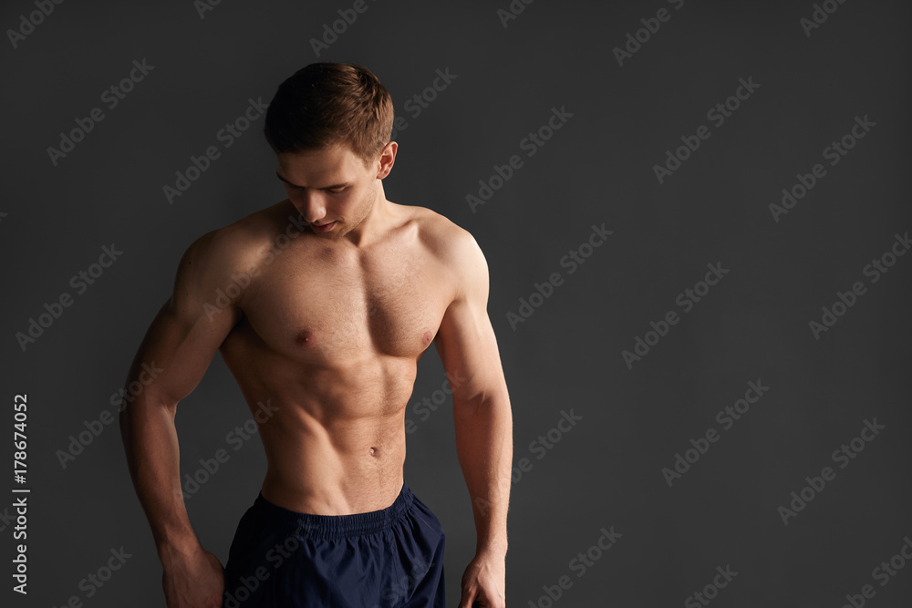 Muscular sportsman showing body
