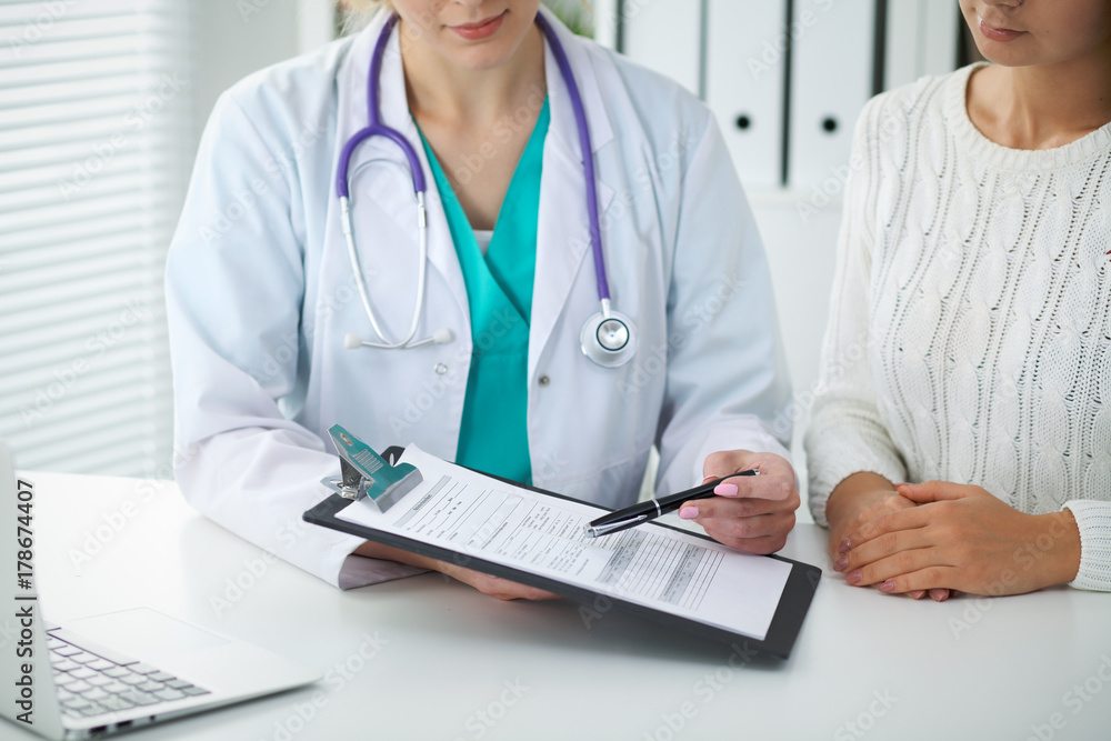 Doctor and patient, close-up of hands. Physician talking about medical examination results. Medicine, healthcare and helping concept Doctor and patient, close-up of hands. Physician talking about medical examination results. Medicine, healthcare and helping concept