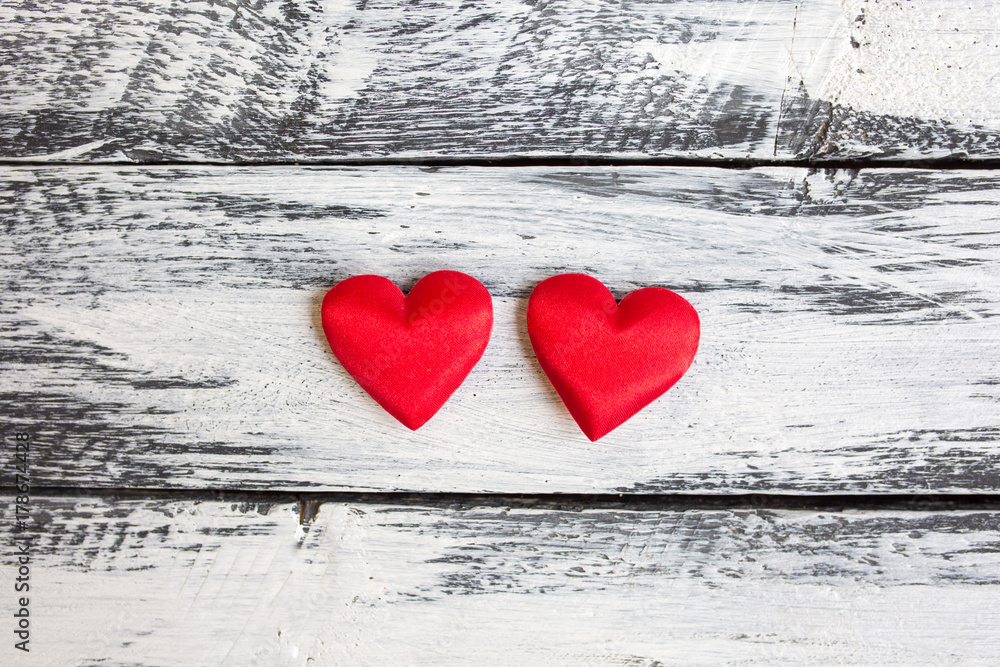 St. Valentine day background. Two red hearts on a wooden table St. Valentine day background. Two red hearts on a wooden table