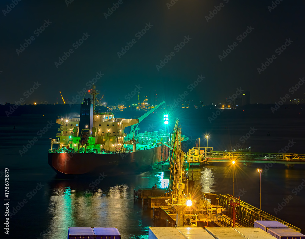 Oil products tanker under cargo operations at night