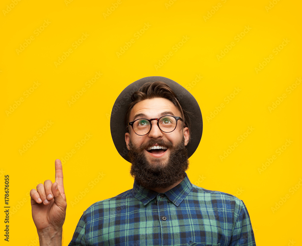 Content man pointing up on orange Content man pointing up on orange