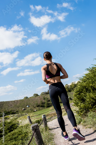 woman jogging on rural road