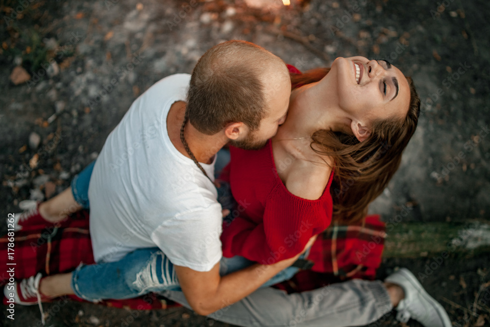 Enamored couple sits and hugs on picnic in forest. Enamored couple sits and hugs on picnic in forest.