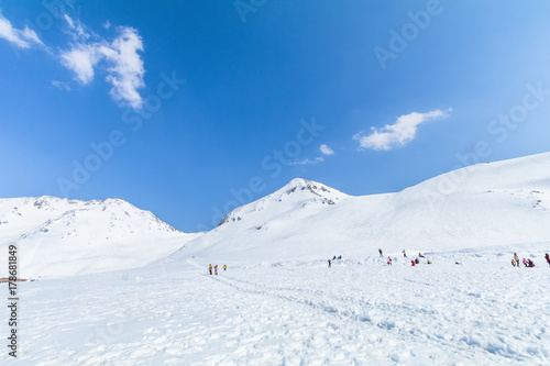  The snow mountains of Tateyama Kurobe alpine  with blue sky  background is  one of the most important and popular natural place in Toyama Prefecture, Japan. © Umarin