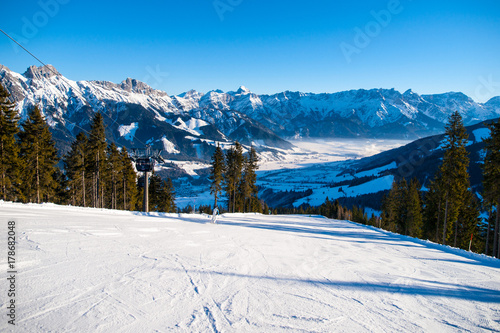 Panoramic view of winter mountains. Alpine peaks covered by snow.