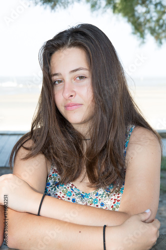 Outdoors portrait of beautiful young girl in bright colorful dress