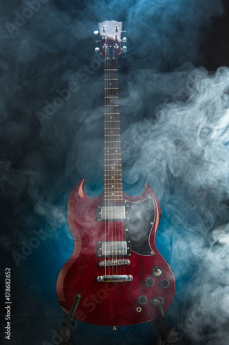 Fototapeta Naklejka Na Ścianę i Meble -  electric guitar in smoke, blue background