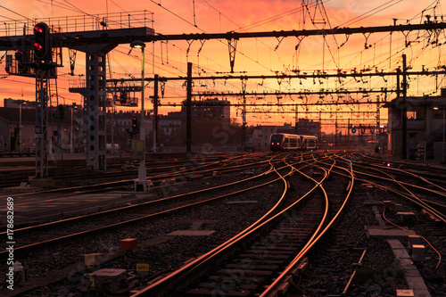 A train on the railroad tracks during sunrise. Gare de Lyon-Perrache, Lyon, France.