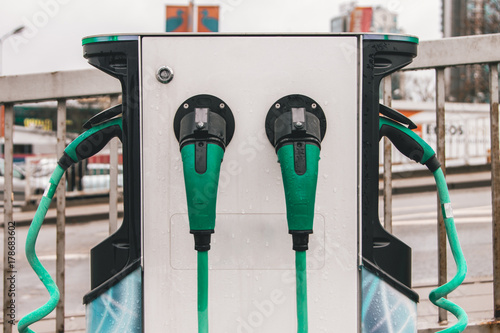Charger for electric cars in a green color on the parking lot