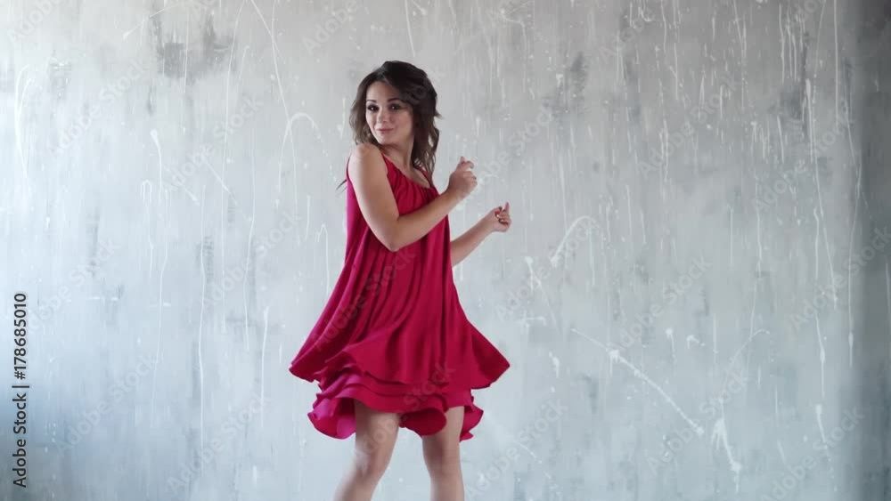 cheerful carefree girl throws up candy and laughs. girl at the party. attractive young woman in red dress. the girl with smoky eyes. cheerful carefree girl throws up candy and laughs. girl at the party. attractive young woman in red dress. the girl with smoky eyes.