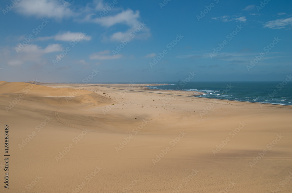 View towards Walvisbay from sand dune near Swakopmund, showing sea edge and oil drill towers View towards Walvisbay from sand dune near Swakopmund, showing sea edge and oil drill towers