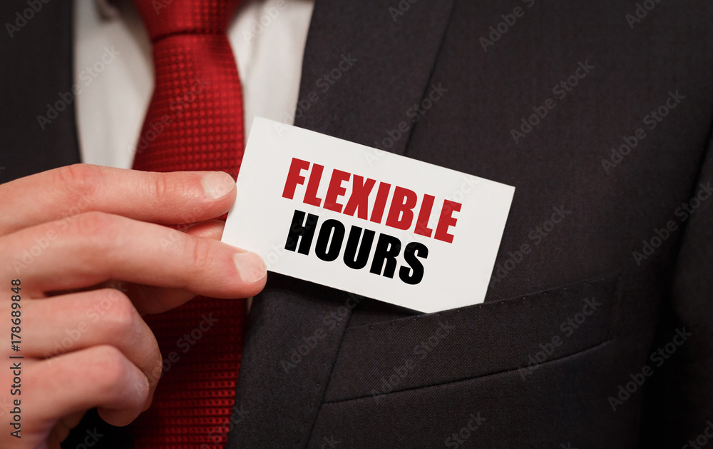 Businessman putting a card with text FLEXIBLE HOURS in the pocket Businessman putting a card with text FLEXIBLE HOURS in the pocket