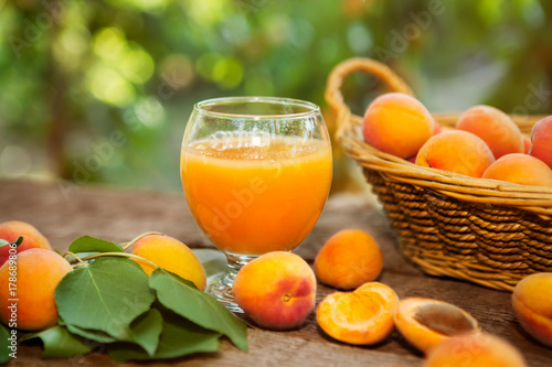 Glass with apricot juice and fresh apricots