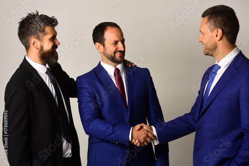 Vászonkép CEOs shake hands on light grey background