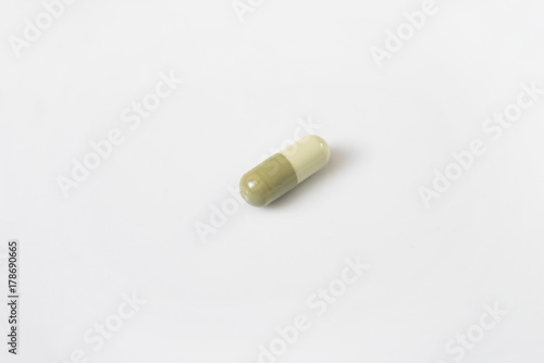 alone green medicine pill on white background
