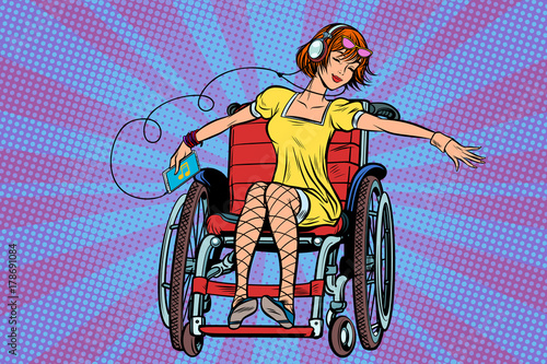 Modern joyful teen girl disabled in a wheelchair, listening to m