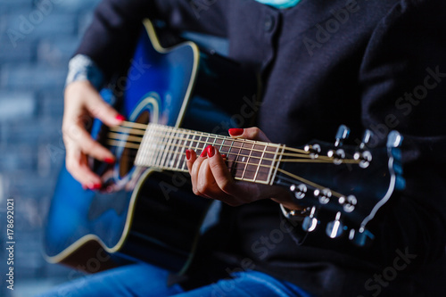 hand playing folk guitar action design