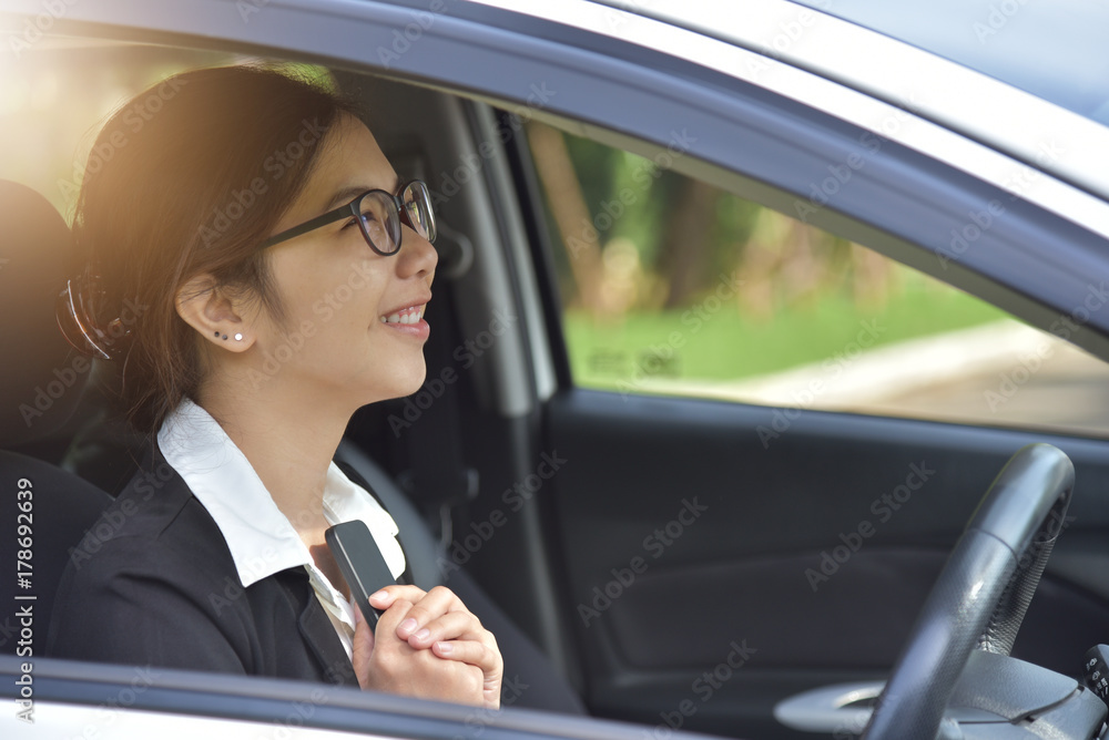 Asian Business woman in glasses holding smart phone.