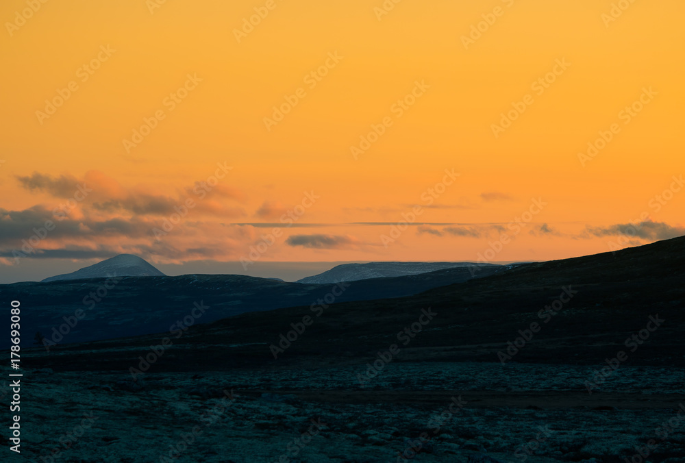 Fototapeta premium A beautiful, colorful sunset in mountains. Beautiful autumn in Norway. Abstract colorful look.