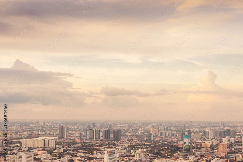 Background and copy space of cityscape concept with cloud and sky at the twilight time or sunset time with soft focus and pastel tone