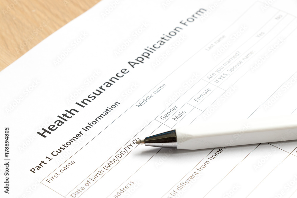 Health insurance application form wait to fill information on desk background Health insurance application form wait to fill information on desk background