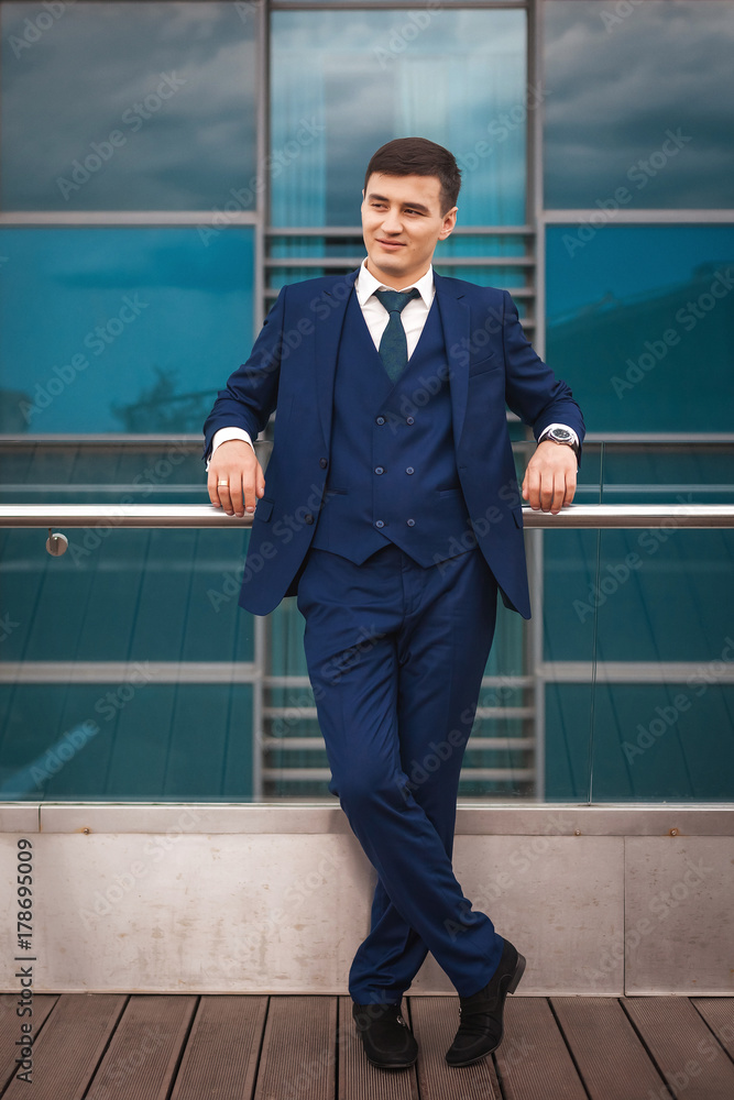 groom in a blue suit waiting for his bride groom in a blue suit waiting for his bride