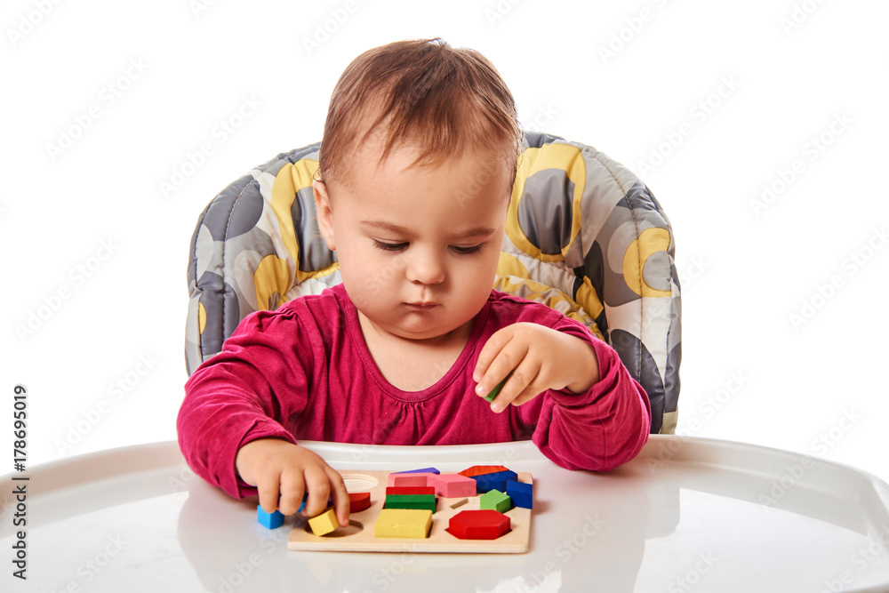 Child little girl learning to use colorful logic game isolated on white background Child little girl learning to use colorful logic game isolated on white background