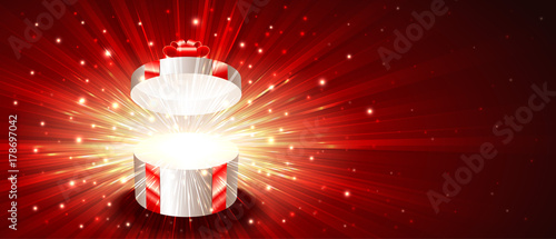 Open gift box with exploding firework of glitters on light rays. Greeting card for Christmas, New Year, Birthday. Vector background banner of postcard illustration. Flyer leaflet proportion 8.5x3.66