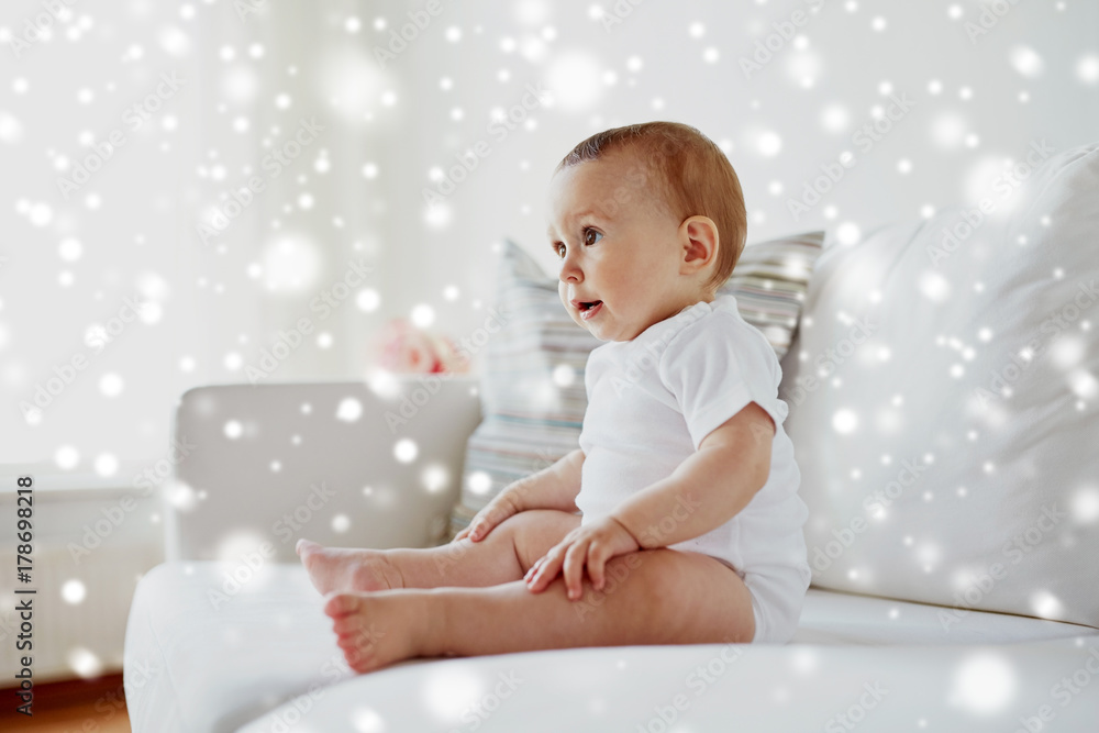 happy baby boy or girl sitting on sofa at home happy baby boy or girl sitting on sofa at home