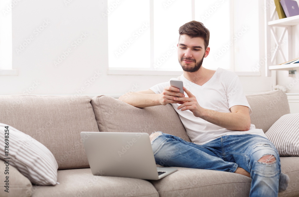Young man at home messaging online on laptop Young man at home messaging online on laptop