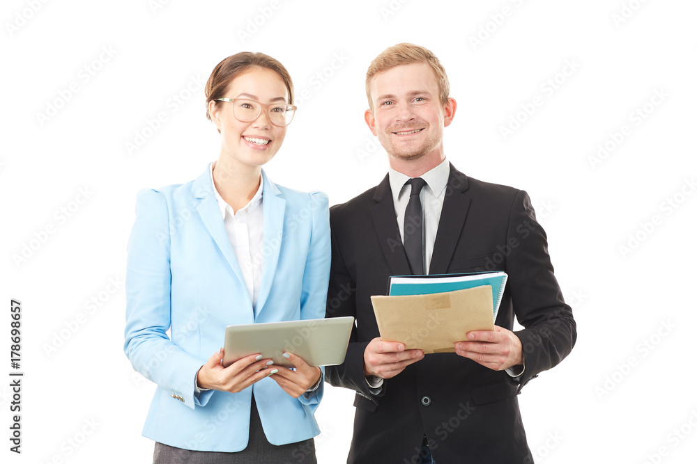 Portrait of Asian businesswoman and Caucasian businessman holding tablet computer and documents