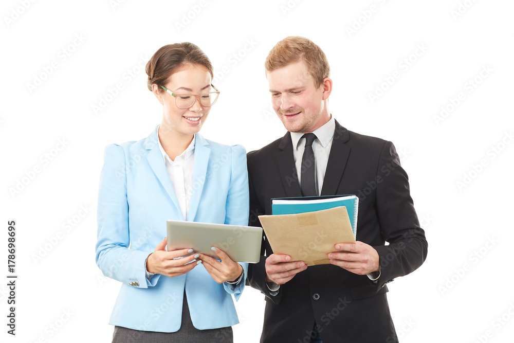Portrait of Asian businesswoman and Caucasian businessman holding tablet computer and documents Portrait of Asian businesswoman and Caucasian businessman holding tablet computer and documents