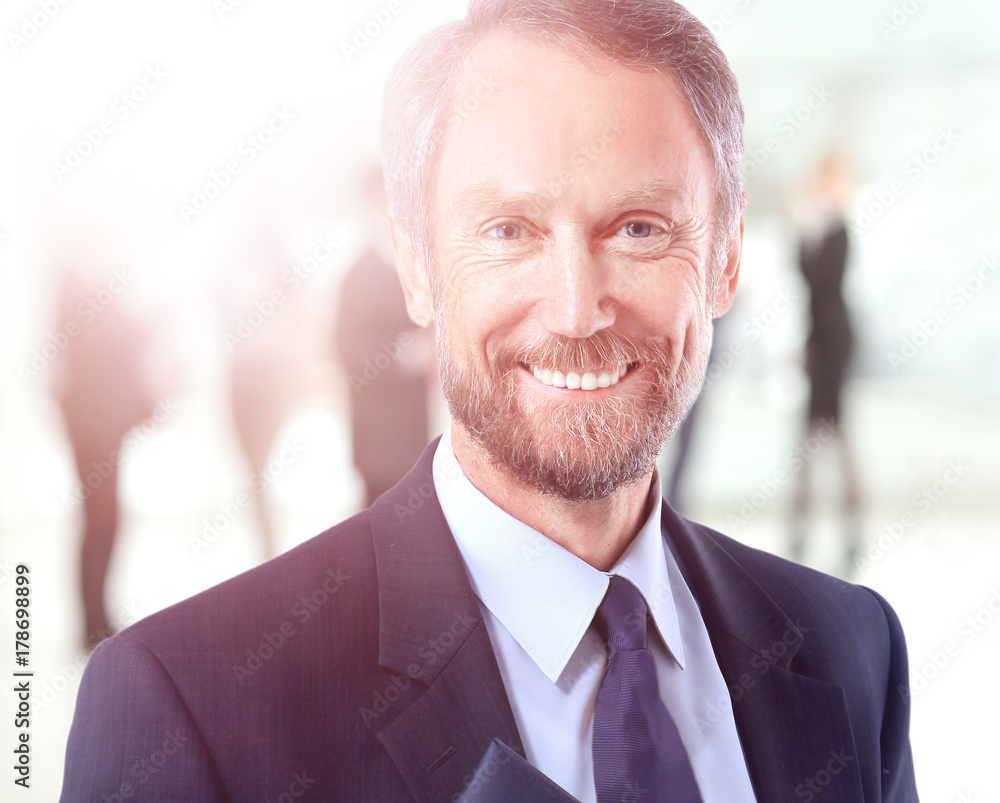 Happy mature business man looking at camera with satisfaction at office