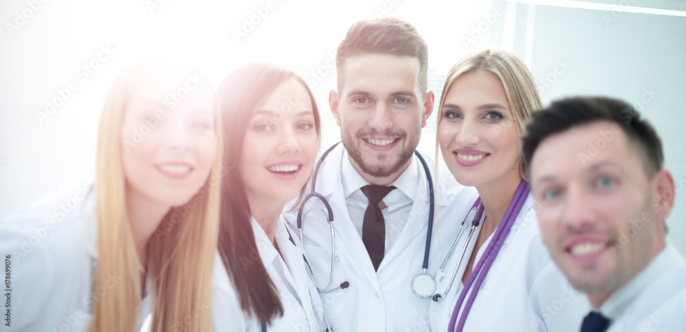Smiling team of doctors at hospital making selfie. Smiling team of doctors at hospital making selfie.