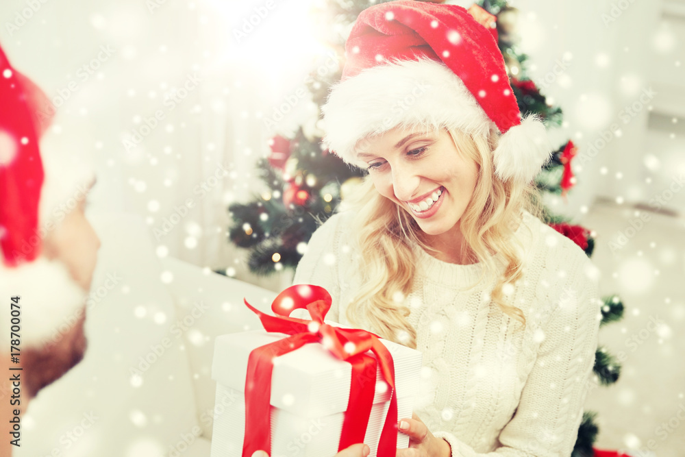 happy couple at home with christmas gift box happy couple at home with christmas gift box