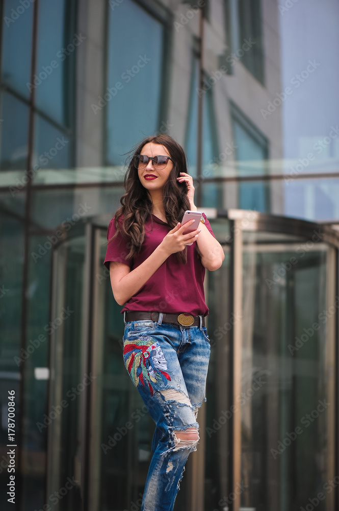 Girl with sunglasses using mobile phone