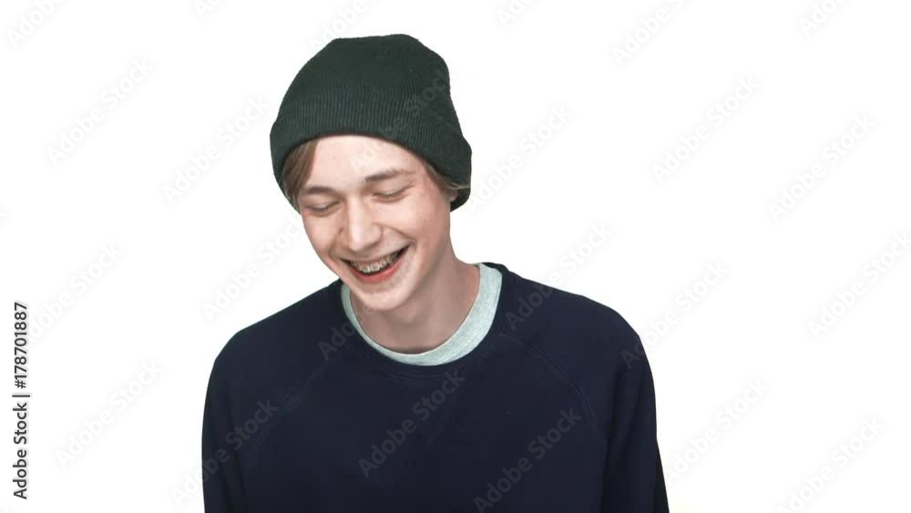 slowmotion portrait of happy teenage boy in braces wearing hat laughing smiling on camera isolated over white background closeup. Concept of emotions slowmotion portrait of happy teenage boy in braces wearing hat laughing smiling on camera isolated over white background closeup. Concept of emotions