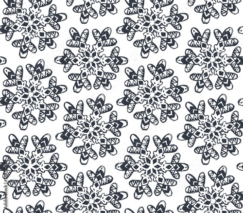 Seamless pattern with hand drawn snowflakes.