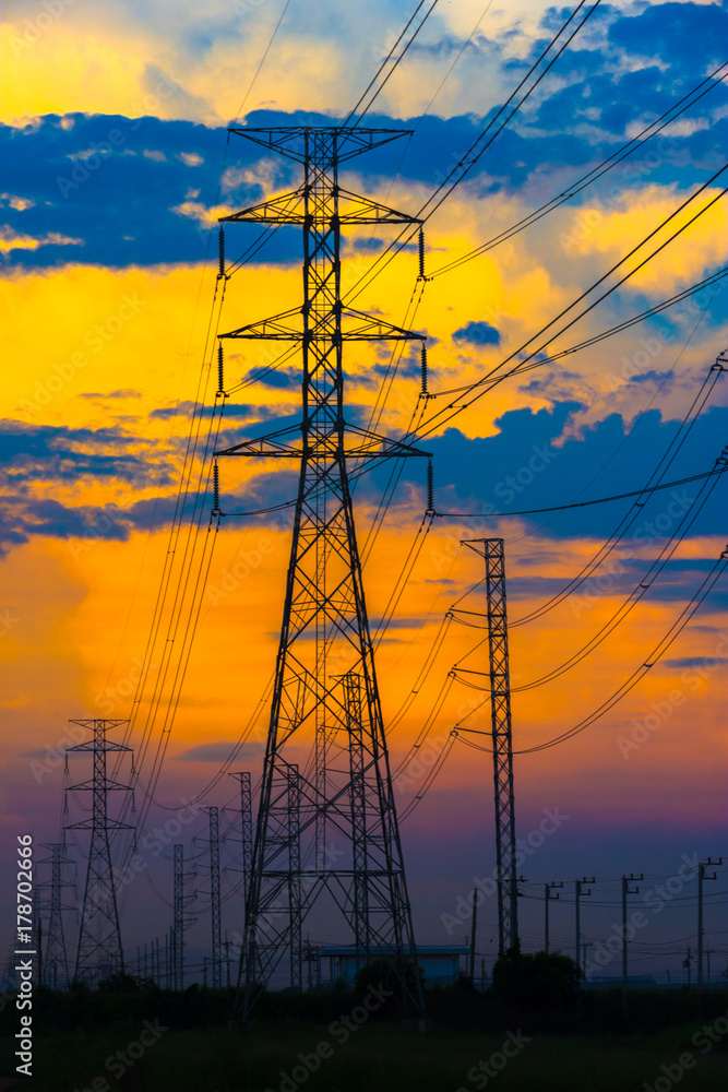 Electricity station. Close up high voltage power lines at sunset.