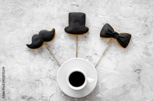 Men birthday concept. Cookies in shape of black tie, mustache, hat. Grey stone background top view