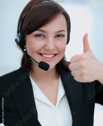 Beautiful woman working at callcenter, using headset showing thu