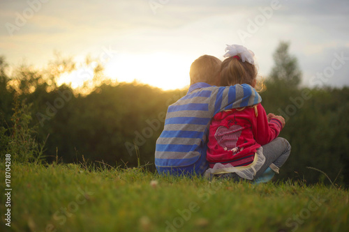 two kids Children embrace on Sunset, romantic boy and girl