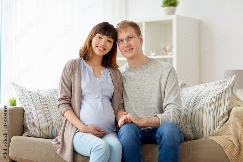 happy pregnant wife with husband at home